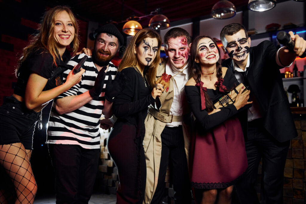 friends is on the thematic halloween party in scary makeup and costumes have fun and posing for the camera together