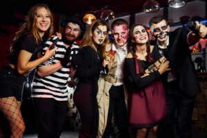 friends is on the thematic halloween party in scary makeup and costumes have fun and posing for the camera together